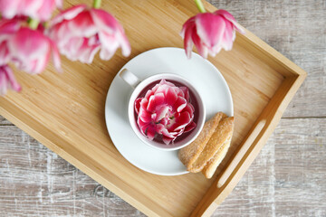Fototapeta premium Breakfast with flowers. Cup on tray