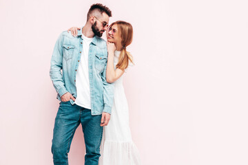 Sexy smiling beautiful woman and her handsome boyfriend. Happy cheerful family having tender moments near wall in studio.Pure cheerful models hugging.Embracing each other. Cheerful and happy