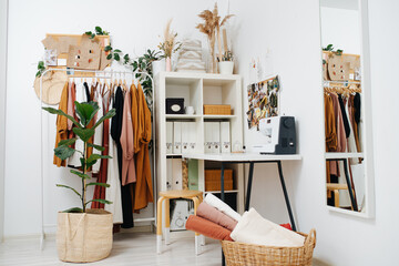 Seamstress's work place in the cornor of a room with a sewing machine.
