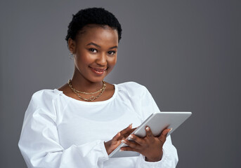 There are tons of fast and easy ways to make money online. Shot of a young woman using a digital...