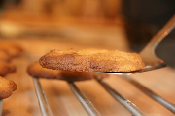 tasty chocolate chip cookies fresh from the oven cooling in the kitchen.  family homemade treat 