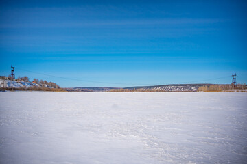 Winter view on the frozen river Tom in the vicinity of the Siberian city of Kemerovo