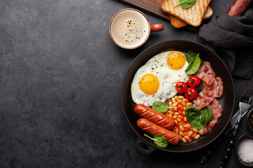 English breakfast with fried eggs, beans, bacon and sausages