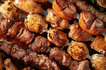Assorted grilled caucasian shashlik kebabs on the wooden board