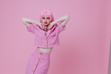 Portrait of a charming lady gestures with his hands with a pink jacket color background unaltered