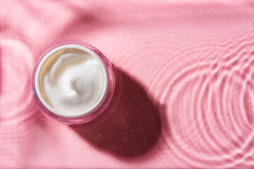 beauty cream on pink clear water