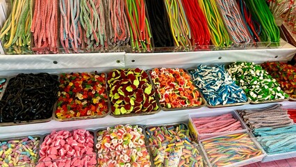 Different sweets on the counter are laid out all the colors of the rainbow as much as the saliva...