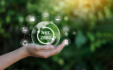 Net zero icon and carbon neutral concept in the hand for net zero greenhouse gas emissions target Climate neutral long term strategy on a green background. - obrazy, fototapety, plakaty