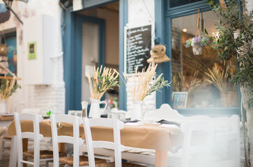 Greek tavern, a bundle of wheat ears on the table looks rustic. Greek tavern in the center of Ermoupolis in Syros great place to eat and have lunch with friends