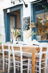 Greek tavern, a bundle of wheat ears on the table looks rustic. Greek tavern in the center of Ermoupolis in Syros great place to eat and have lunch with friends