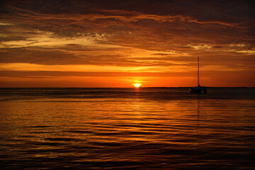 Golden sunset at the sea. landscape with sunset over the ocean, boat, sailboat.
