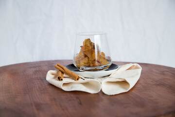 Caramelized apple dessert on wooden table. Baked or roast apple with cinnamon.