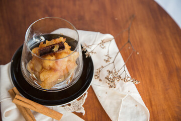 Caramelized apple dessert on wooden table. Baked or roast apple with cinnamon.