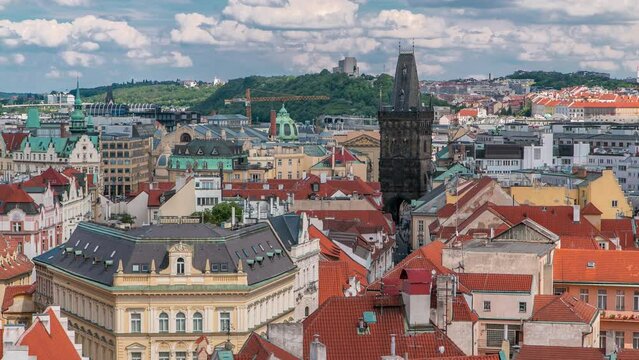 Aerial view of the traditional red roofs of the city of Prague, Czech Republic with the Powder tower and Vitkov Hill in the distance timelapse.