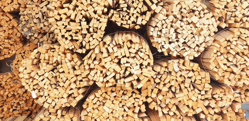 Panorama of bundles of firewood on a winter day.