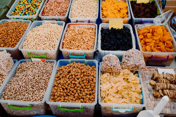 Turkish delight with various nuts and dry fruits are poured into containers and sold at the market, bazaar