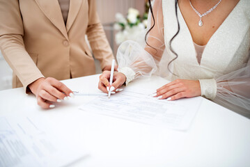 The bride signs the marriage in the department of state registration of civil status