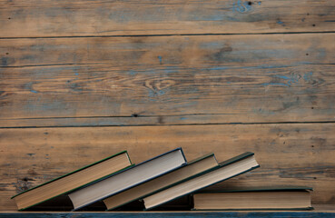 Many stack books on wooden background. Back to school with copy space.