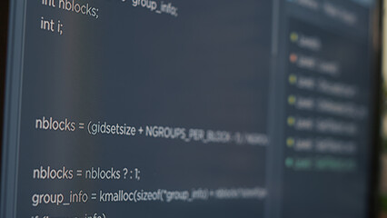 Closeup of computer screen of system engineer typing source code in it startup agency. Display...