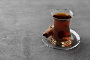 Turkish tea in traditional glass on gray background