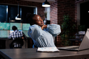 Forex stock market trading agency professional agent with neck pain sitting at desk in office...