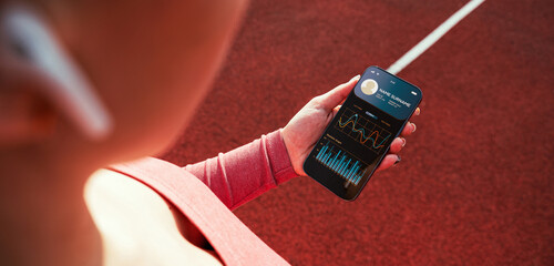 Gym app. Smartphone screen with sport gym or fitness health mobile application. Woman holding app for training indoors.