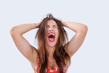 young woman with her hands on her head and screaming