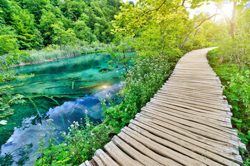 jetty with sunshine on the the Gradinsko jezero and Milino Jezero lake of Plitvice Lakes National Park in Croatia in the Lika region. UNESCO World Heritage of Croatia named Plitvicka Jezera.