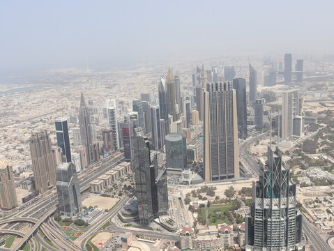 Dubai, UAE- March 31 2022: Daylight view of the skyline of Financial district in a megacity with massive buildings and highways. Dubai Metropolis drone shot.