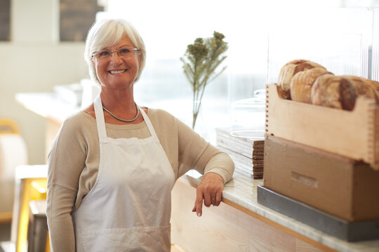 Financial freedom sure feels good. Portrait of a happy senior woman working in a bakery.
