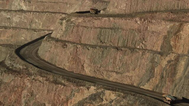 Gold mine haul trucks at the Fimiston Open Pit. The mine produced 456,000 troy ounces (14.2 t) of gold in 2019, and employs around 1,100 employees and contractors.