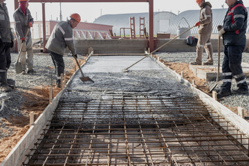 Pouring cement or concrete with a concrete mixer truck, construction site with a reinforced...