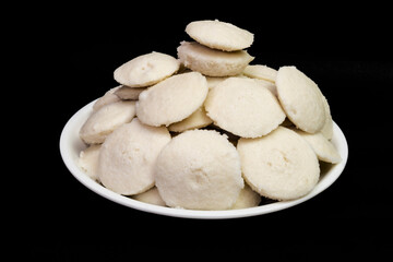 Side View Of Idly In White Plate, Isolated On Black Background