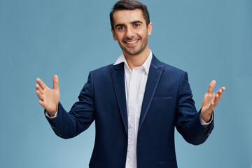 smiling businessman in blue suit throwing up his hands in greeting gesture successful trader isolated background. Copy space
