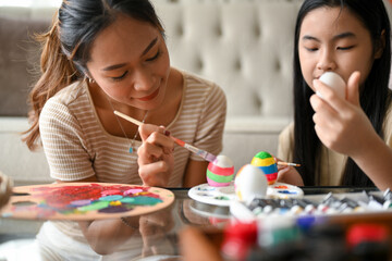 Happy Easter time with a lovely two sisters painting an Easter egg