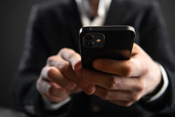 Business, finance and investment, forex trading, currency exchange, economic growth, stock market analysis concept. Man using mobile phone checking stock market graph report via mobile apps