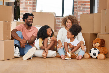 Family is not an important thing, its everything. Shot of a family sitting on the floor in their new home.