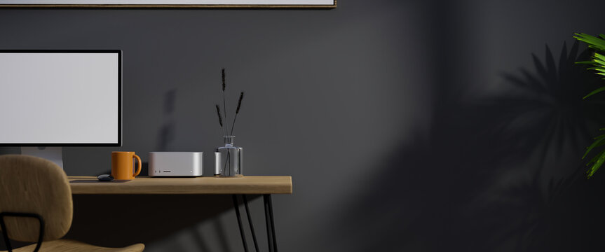 Modern dark Scandinavian workspace with computer on wood table