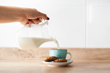 cup of coffee with milk and cookies