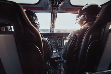 Fotobehang Inside the cockpit of a helicopter in fli © Jameel A/Wirestock Creators