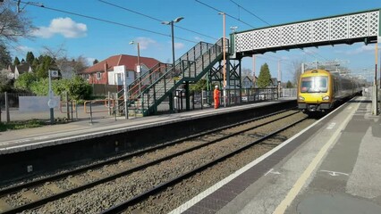 electric train passing through station england uk