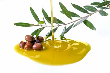 Pouring olive oil with olives and branch with olive leaves isolated on white