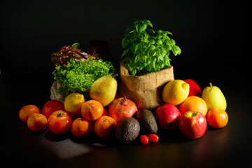 Fresh fruit composition with herbs on black background.
