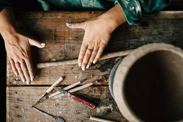 Female potter rolling clay in workshop