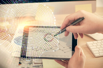Double exposure of man's hand holding and using a digital device and brain hologram drawing. Data...