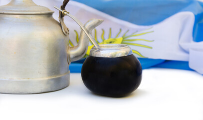 a mate and a kettle with the Argentine flag