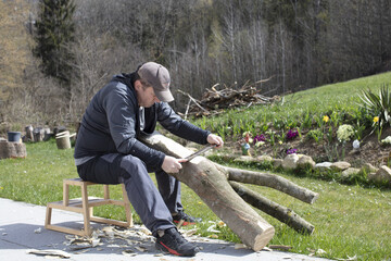 Wood carving man out in the sun