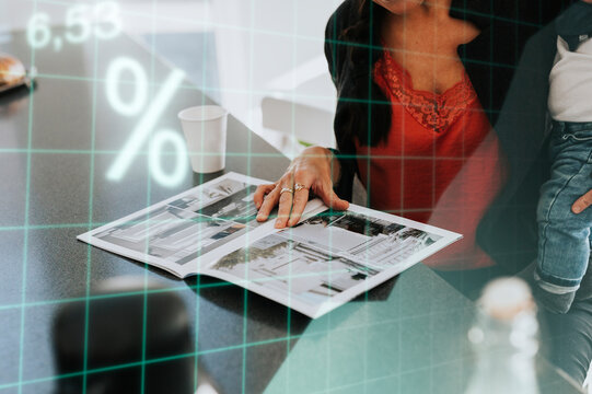 Mother holding child and looking at catalogue