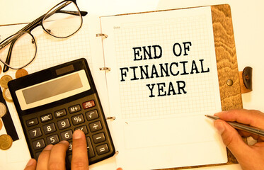 Finance and economics concept. The man is holding a pen and a notebook with the inscription - END...