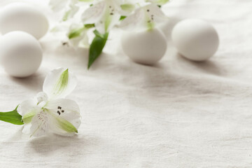 Fototapeta na wymiar White flower and white eggs. Happy easter concept